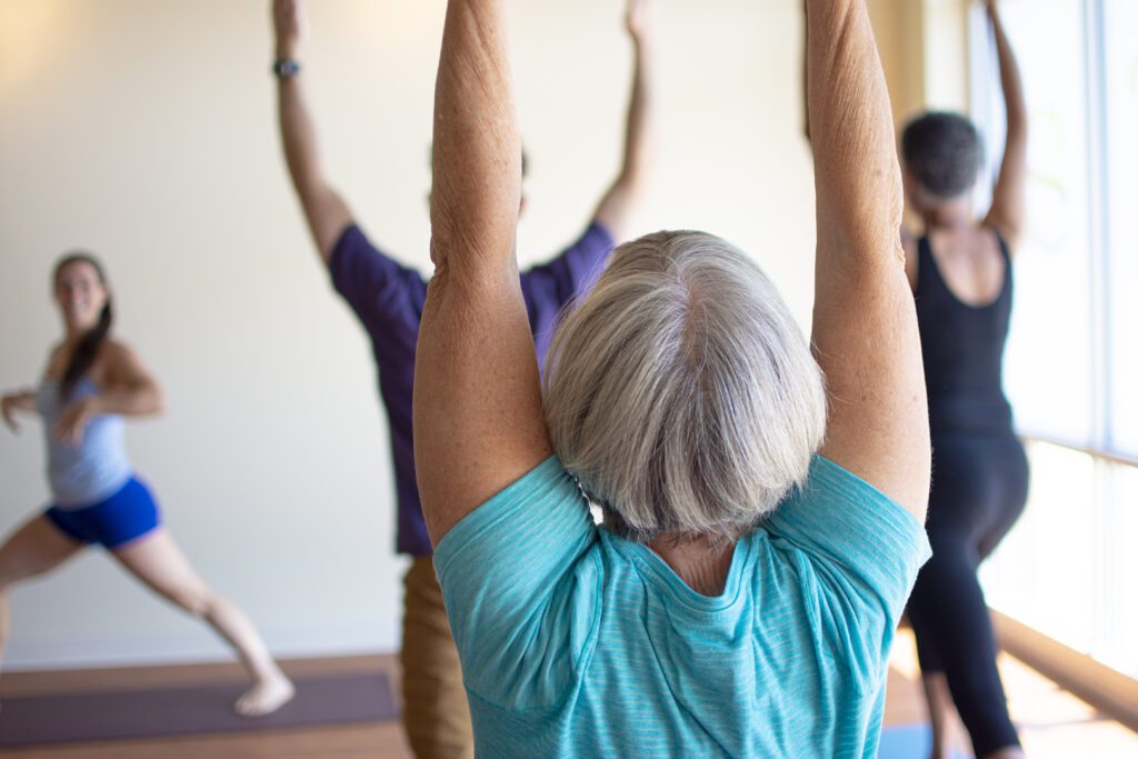 students of various ages practice in a sunny room